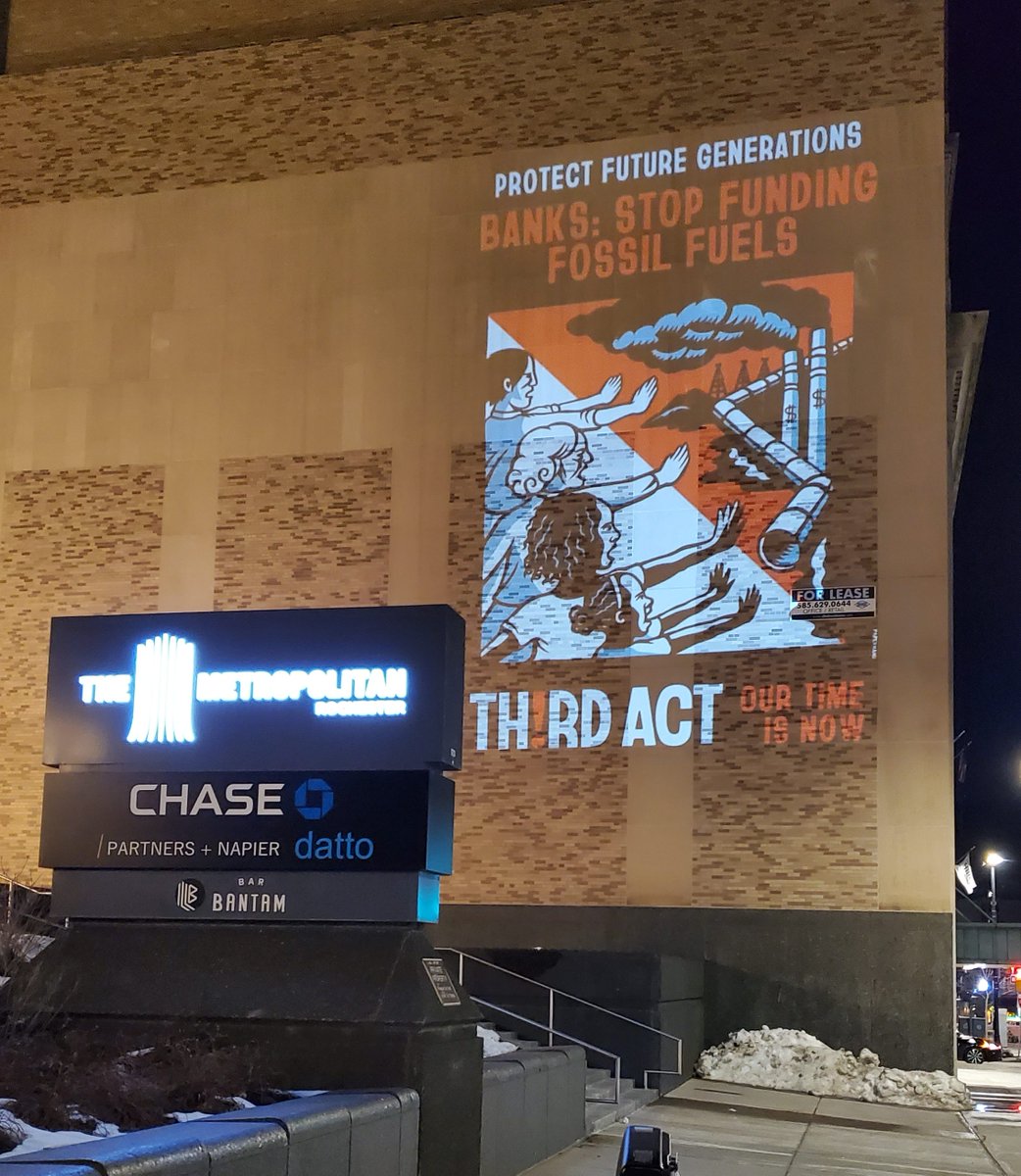 billmckibben's tweet photo. Holy mackerel! 
Images are flooding in from across the continent as we prepare for Tuesday's big @ThirdActOrg  bank protests. These are from NorCal, and from Rochester NY: night-time projections reminding fossil-fueled banks we know their game. https://t.co/ohRhowaq1k