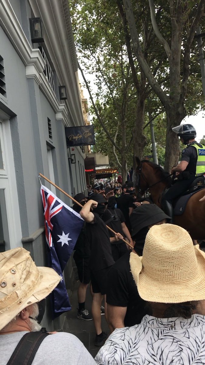 LensCompassion's tweet photo. The time frame of when the Nazis were at Melbourne Parliament are:
11:40am - Arrived.
12:33pm - Stood on the steps of Parliament.
12:48pm - Stepped off the steps of Parliament and the police escorted them out and down Spring Street. 
#acab #TERFs https://t.co/vjlJnObvvE