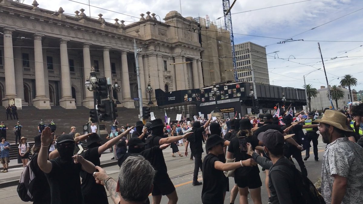 LensCompassion's tweet photo. The time frame of when the Nazis were at Melbourne Parliament are:
11:40am - Arrived.
12:33pm - Stood on the steps of Parliament.
12:48pm - Stepped off the steps of Parliament and the police escorted them out and down Spring Street. 
#acab #TERFs https://t.co/vjlJnObvvE