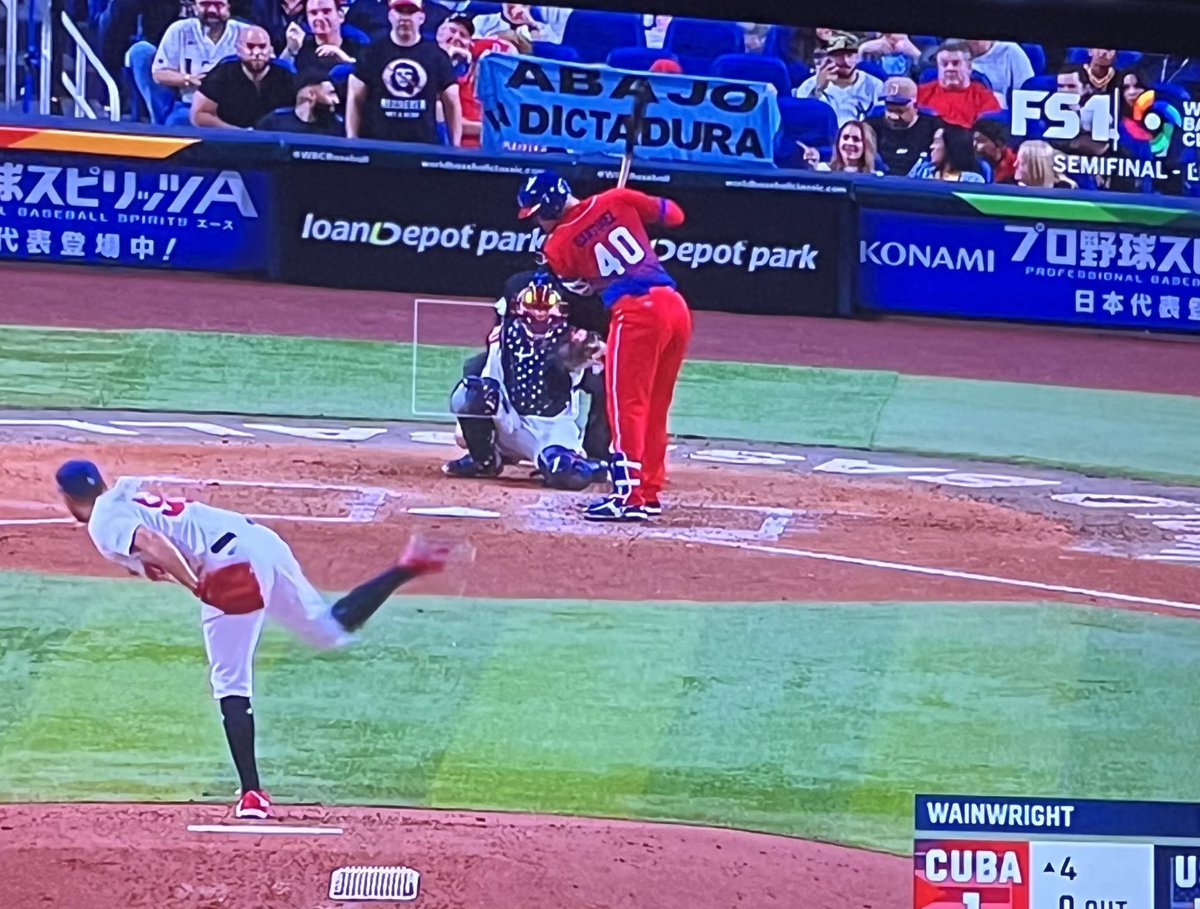 ChrisCorrea15's tweet photo. Some of the protests during the USA vs Cuba semifinal game of the World Baseball Classic. Also saw video of demonstrations outside Marlins Park prior to first pitch. Now fans behind homeplate seem to be distracted with something near the Cuban dugout. https://t.co/Q3sax5sry9