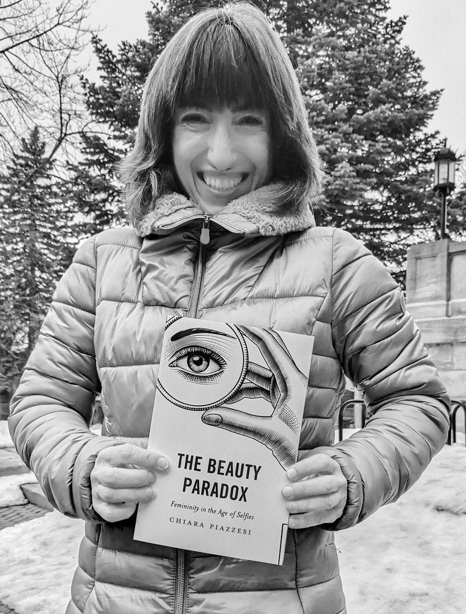 Caption: Elated, grinning non-fiction author touching her newly published book for the first time. Credits: Jacinthe Laporte @RLPGBooks @UQAM @fshUQAM @irefUQAM #beautyparadox #sociology #beauty #wellbeing #feminist #bodypositive #bodypositivity #womensupportingwomen #montreal