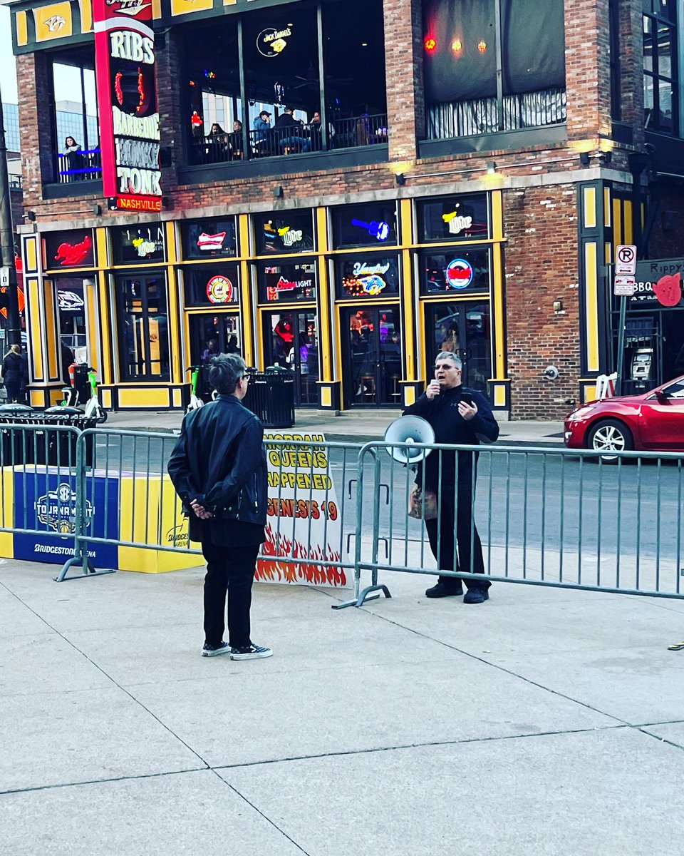KristieHelms's tweet photo. Just my wife standing in defiance of a man in downtown Nashville telling us we’re going to hell. #loverising #LGBTQ https://t.co/lxaDzmhI4K