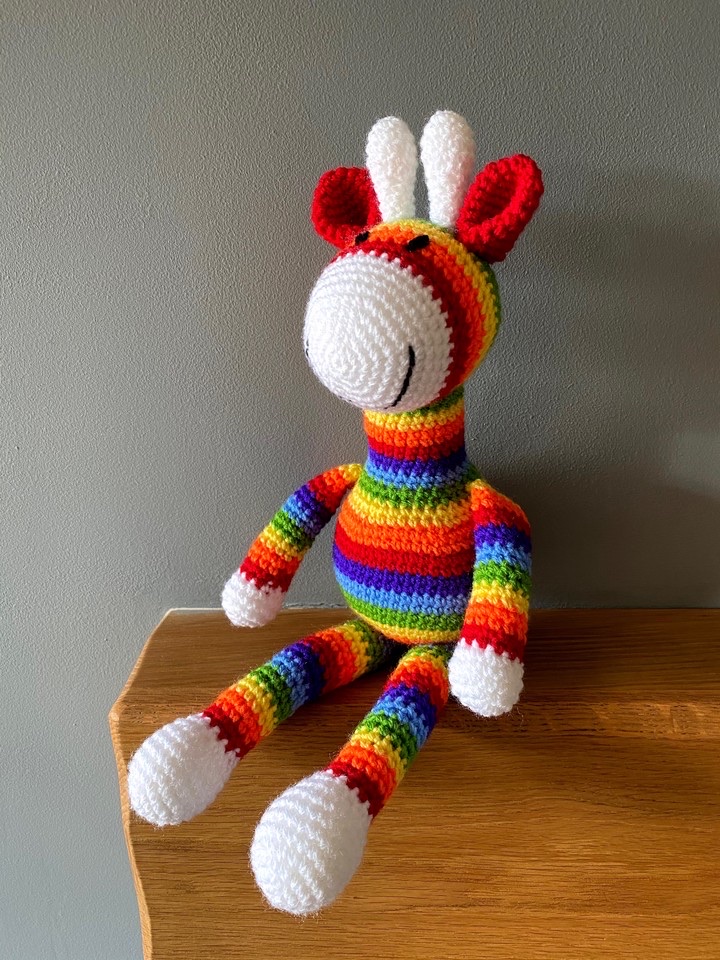 Rainbows can brighten anyone’s day 😊 This sweet giraffe is made to order and can be crocheted in any colour combination you choose! etsy.me/3wkd47t #firsttmaster #handmade #giftidea #atsocialmedia #craftbizparty #UKMakers #MHHSBD