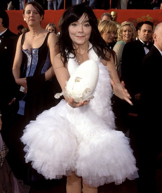 dailybjork's tweet image. björk hatching an egg at the 2001 oscars