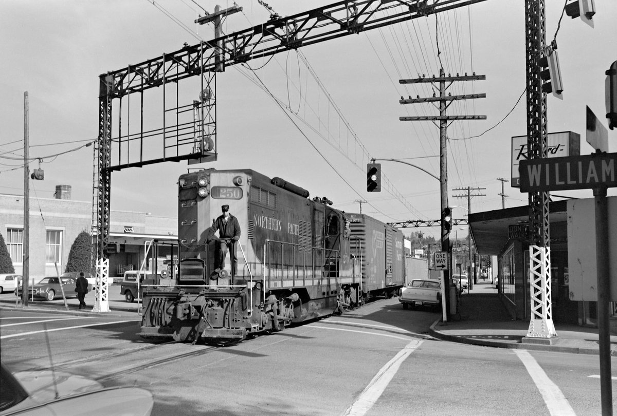 It's #WorkerWednesday, and we hope you’re feeling as cool as this Burlington Northern trainman riding on GP9 250 (in Northern Pacific livery) in Renton WA. Shot by John C. Illman on Oct. 13, 1970. (Illman-04-275).
 #trains #photography