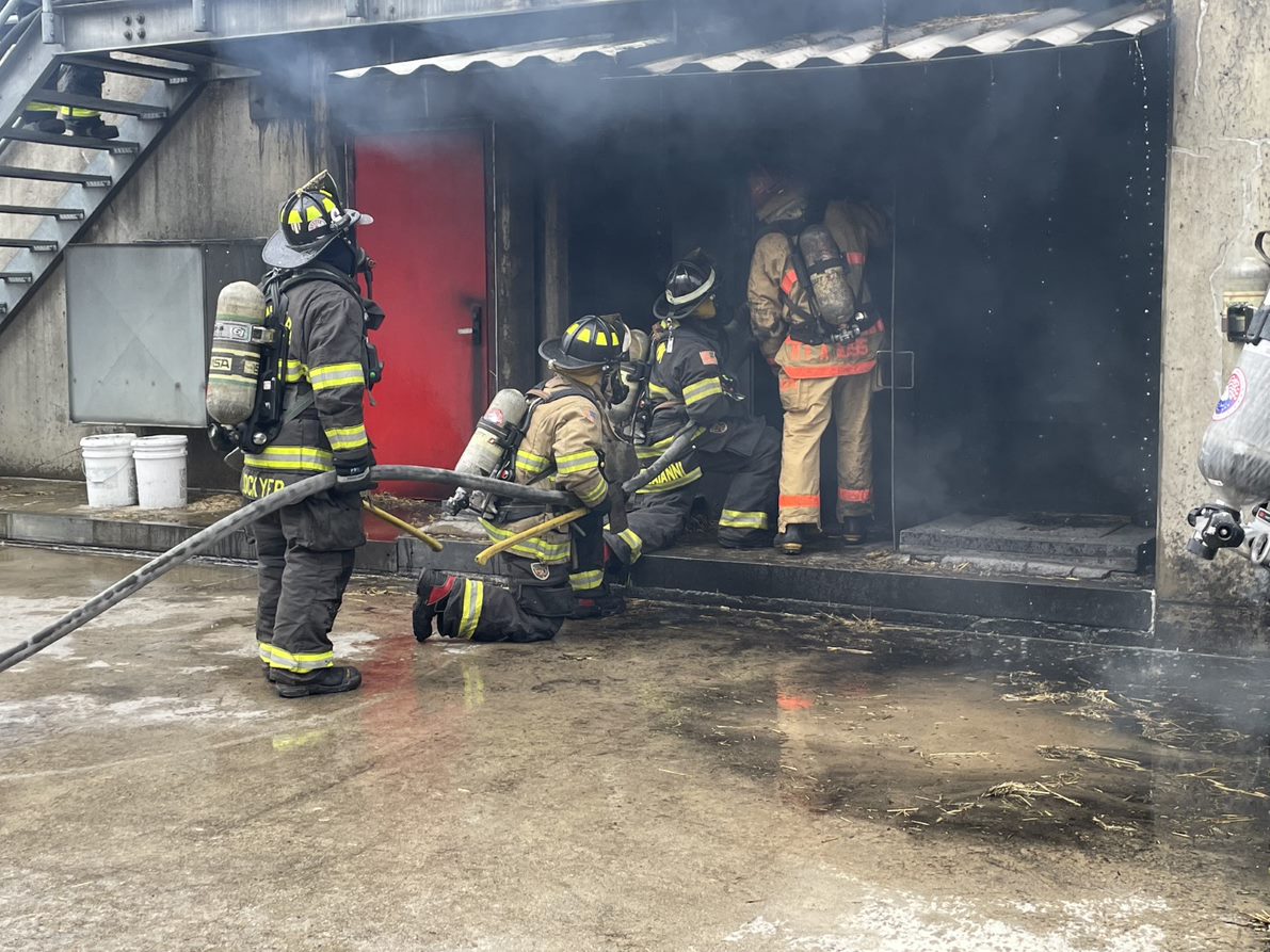 MassDFS's tweet photo. #FirefighterTraining: These firefighters are engaging in firefighting practices according to NFPA 1700, Guide to Structural Firefighting.  They used tactics to cool the environment prior to entry, utilizing a transitional fire attack before advancing the hoseline interior. https://t.co/Op90MJ8dV1