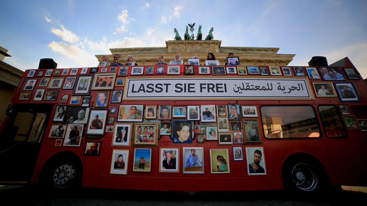 FamiliesSyria's tweet photo. During a #FreedomBus trip to #Paris, we hung pictures of Mazen and Patrick alongside our loved ones. Their immediate family spent the entire day with us, and we will continue to fight until every war criminal is held accountable for their atrocities. (2/3) https://t.co/5oXcgLc4Yd