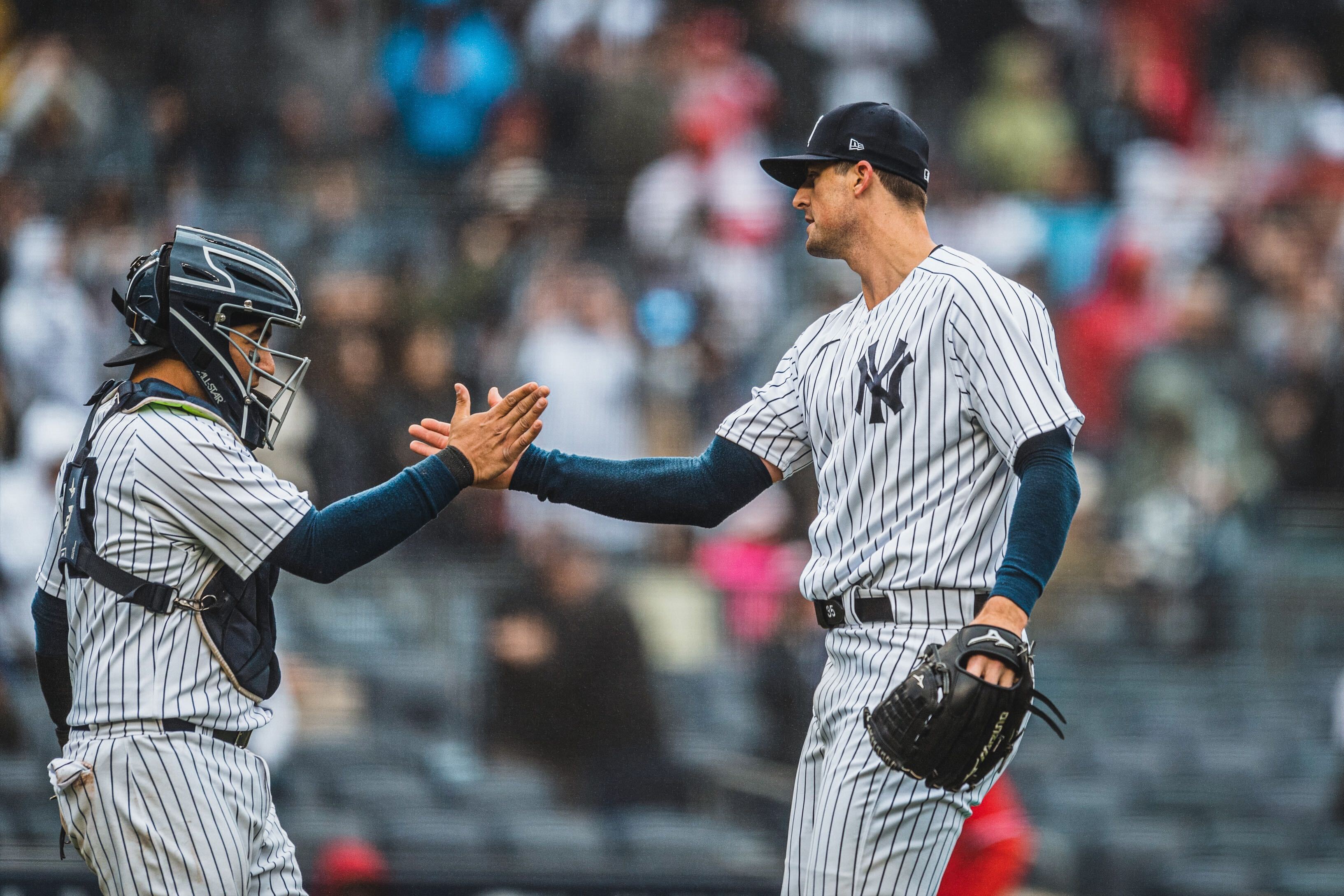 Clay Holmes high-fives Jose Trevino after finishing the game. 