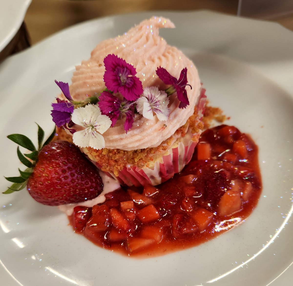 This beauty was the winner of our second Cupcake Challenge! 
It was a vanilla cake with brunoise strawberries filled with cheesecake and a rhubarb/strawberry/ginger compote. American buttercream frosting atop a secret strawberry shortcake crunch.