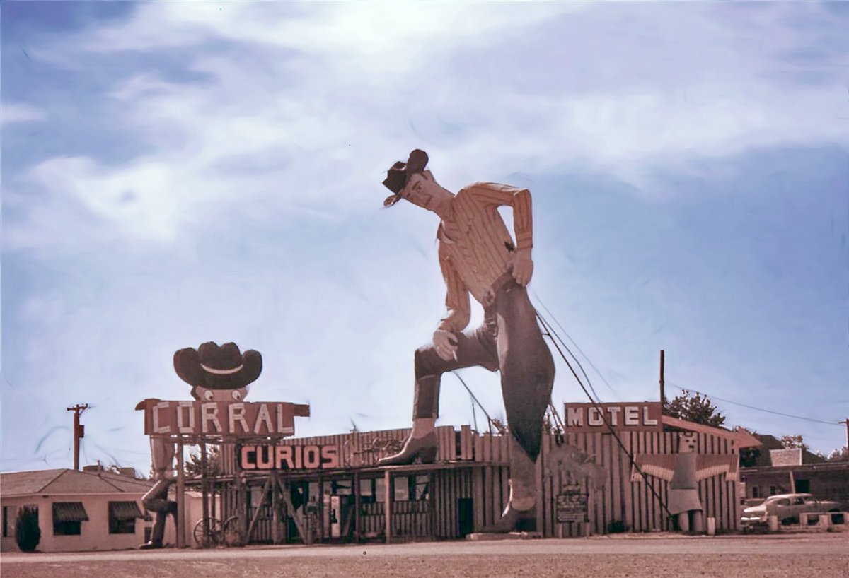 Big Tex Randall in Canyon, Texas,  1960s. Note the cigarette in his hand, which was shot off shortly after this was taken. Big Tex Randall still stands. He's 47' high and weighs seven tons. The statue was constructed in 1959 by local shop teacher Harry Wheeler to advertise for a