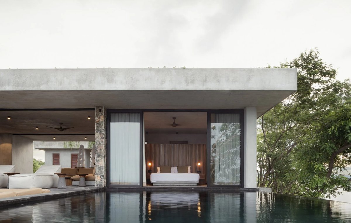 dezeen's tweet photo. Zozaya Arquitectos oriented this Mexican beach house around a reflecting pool: https://t.co/dd2NBx9IlF https://t.co/a6LJVNspOs