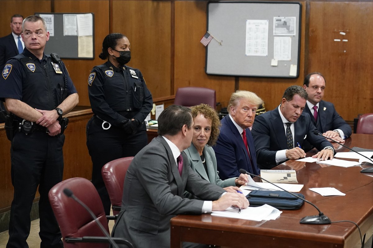 EmilyPurser's tweet photo. First image of Trump in court - flanked by his three lead lawyers https://t.co/17WTAvk8v2