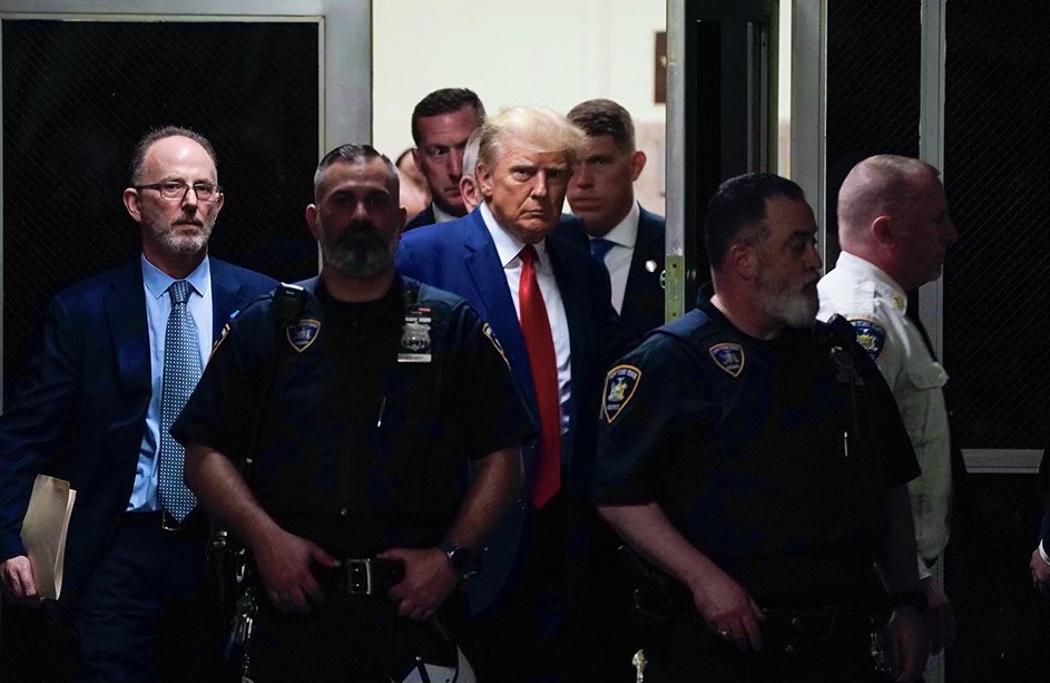Former President Donald Trump walks from the area of the courthouse where he was processed and into the courtroom where his arraignment will take place in New York. #Trump