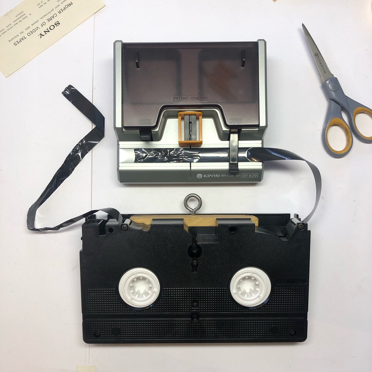 Preparing a VHS tape for splicing with the Kinyo Splicer Kit in the VSW Media Transfer Lab.