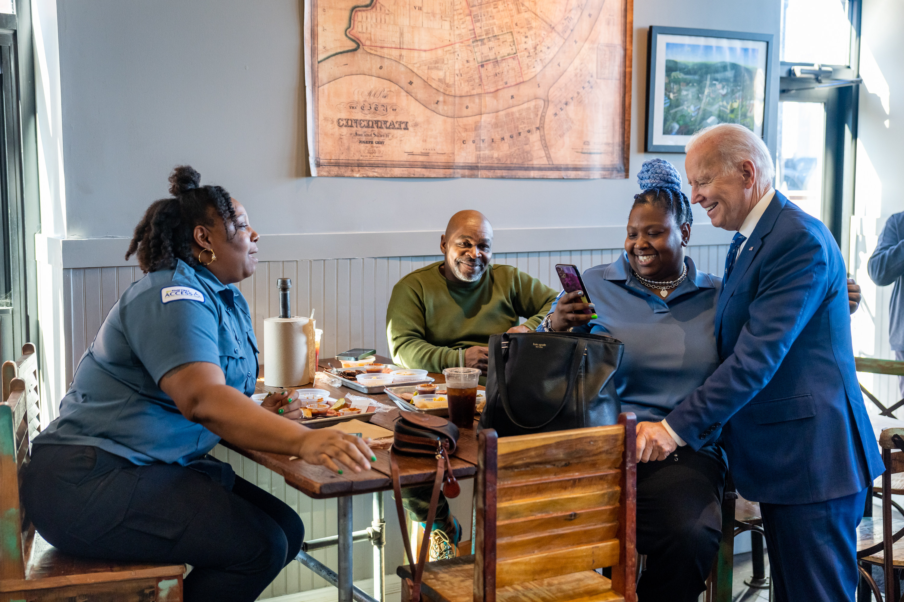 President Biden meets with workers at a small business.
