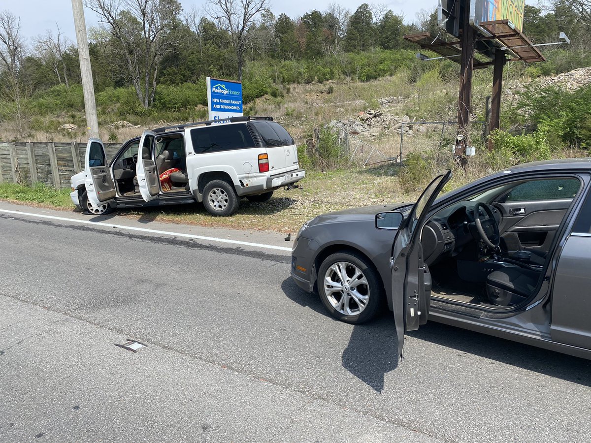MNPDNashville's tweet photo. Madison Precinct detectives were fired upon while attempting to conduct a traffic stop on this white Chevy Tahoe just before 1 p.m. on Dickerson Pk. Three officers returned fire. No one was injured. Suspect in custody. https://t.co/0C2DONnuIs