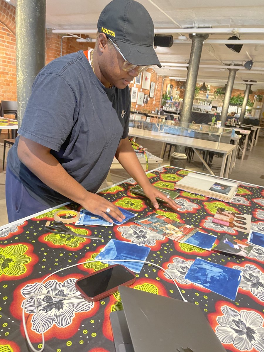 Photo_Oxford's tweet image. Bernice Mulenga at work on their exhibition in ⁦@mao_gallery⁩ entrance/cafe space for #PhotoOxfordFestival. Now open to view until 14 May. #TheHiddenPowerOfTheArchive