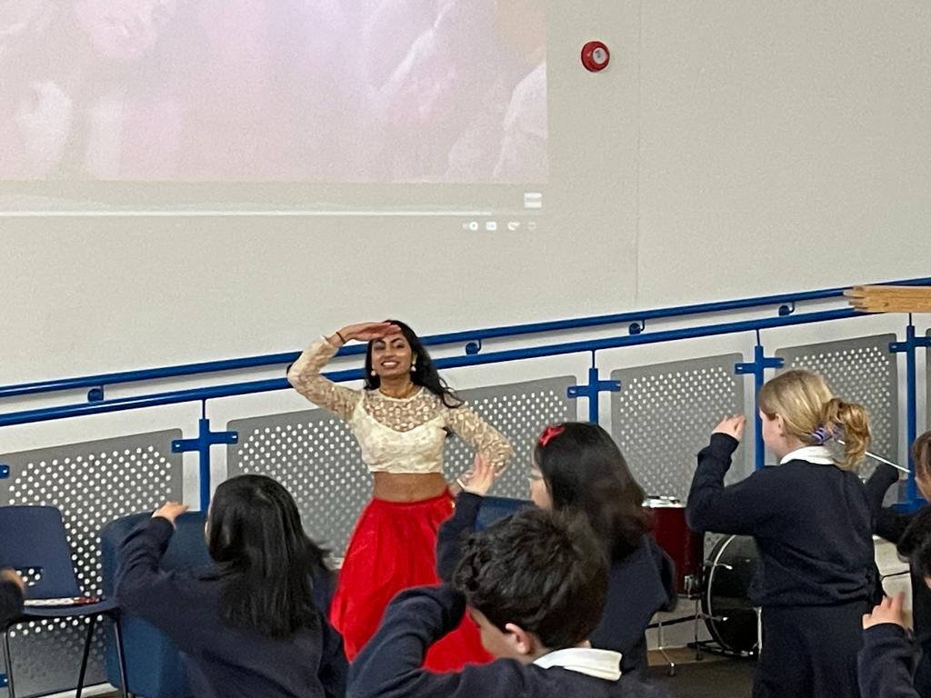 HTPDSchool's tweet photo. Today we welcomed Nishi back to HTPD - she was a previous HTPD student and lead a Hindu dance workshop to help Y5 learn about holi #zestforlearning https://t.co/174kew7XCO