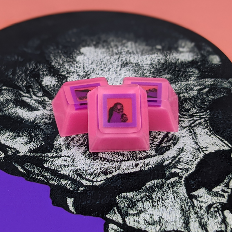 absentience's tweet image. My custom framing job for @cyberbanditsNFT #2287 is complete!

I went with a 0.39 inch purple polyurethane frame encapsulated inside an epoxy keycap. I think the coral really pops on my pink wall, what do you think? ...wait, what?

#NFTkeycap #microframe #FanArtFriday