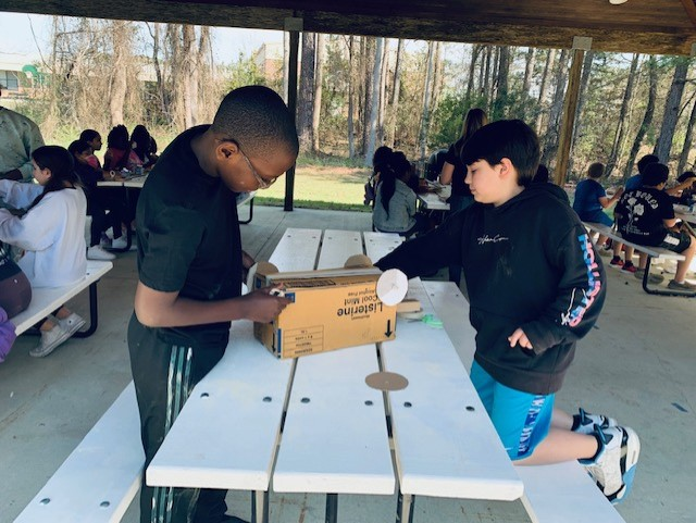 ZebulonMagnetES's tweet photo. Mrs. Bridgers 5th grade class enjoying the beautiful weather today working on Force and Motion Graphs units in science. Students created a mobile unit and next week they will finish up lesson by creating distance time graph!! @ZES_Principal @wcpssmagnets https://t.co/wP2rQ2mz07