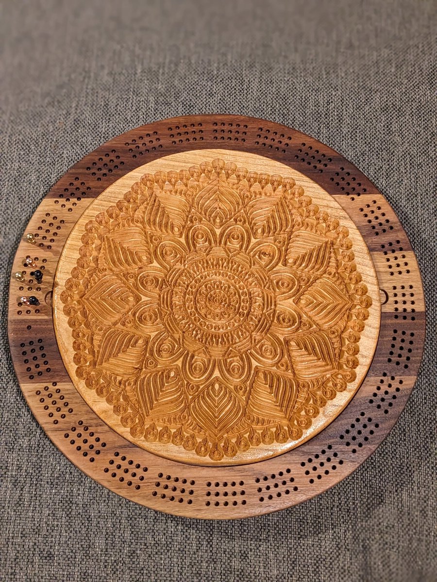 jmauser's tweet photo. Walnut and cherry round three track cribbage board with mandala carved lid and internal storage. https://t.co/vO9iQGgaXT