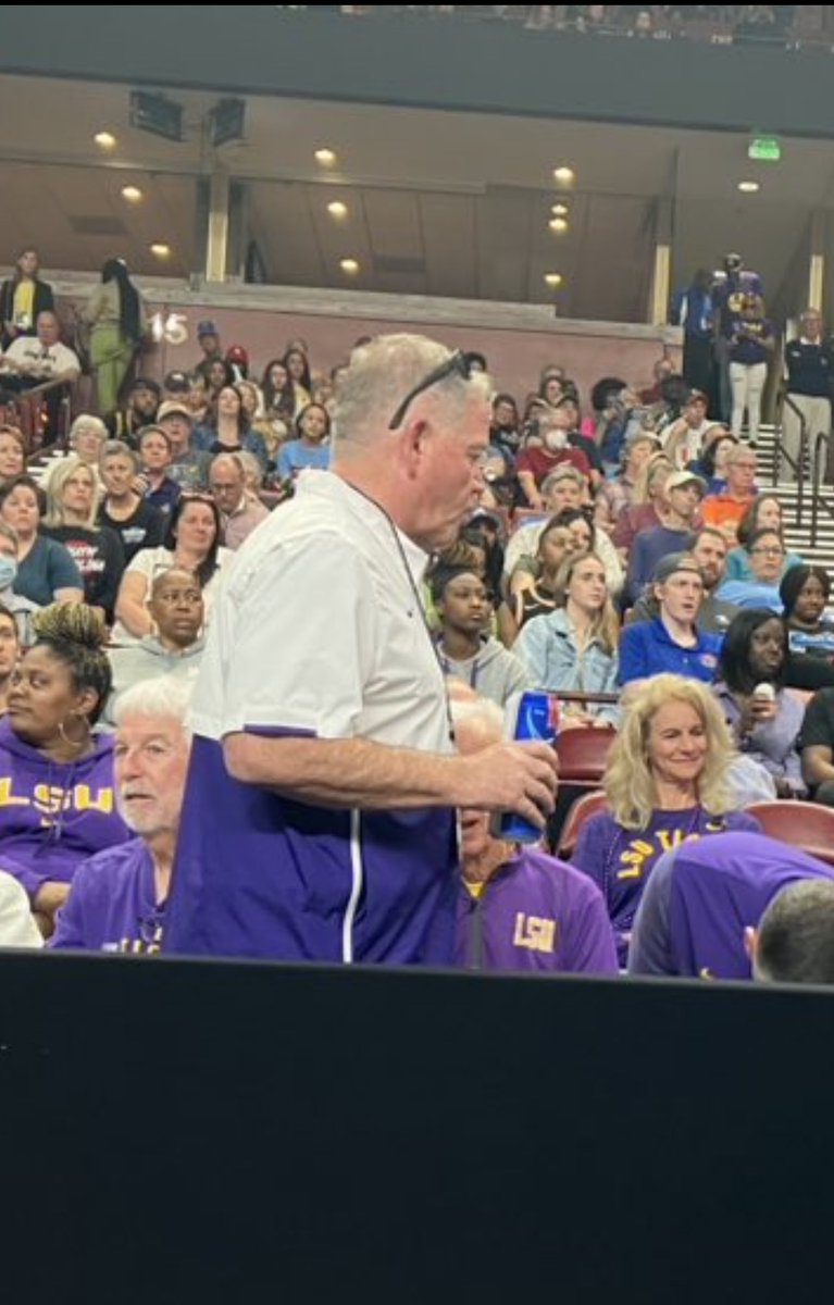 chris_m_landry's tweet photo. Brian Kelly sipping a tall boy watching #LSU play ball. 

One of us! One of us! One of us! 🍻 https://t.co/viyXHqnwre
