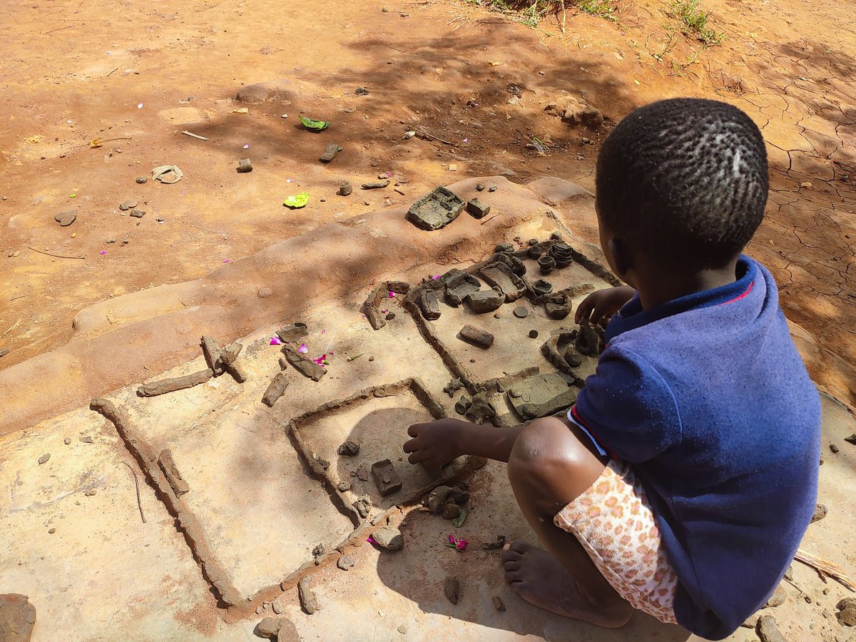 A displaced child from Chilobwe slopes on Mount Soche in #Blantyre City, where mudslides left  100 dead &amp; scores missing, 'builds' a desired homestead at Naotcha Camp,  #Malawi. Children in emergencies reimagine a future in resilient homes. Are U listening? #CycloneFreddy <a href="/UNICEF/">UNICEF</a>