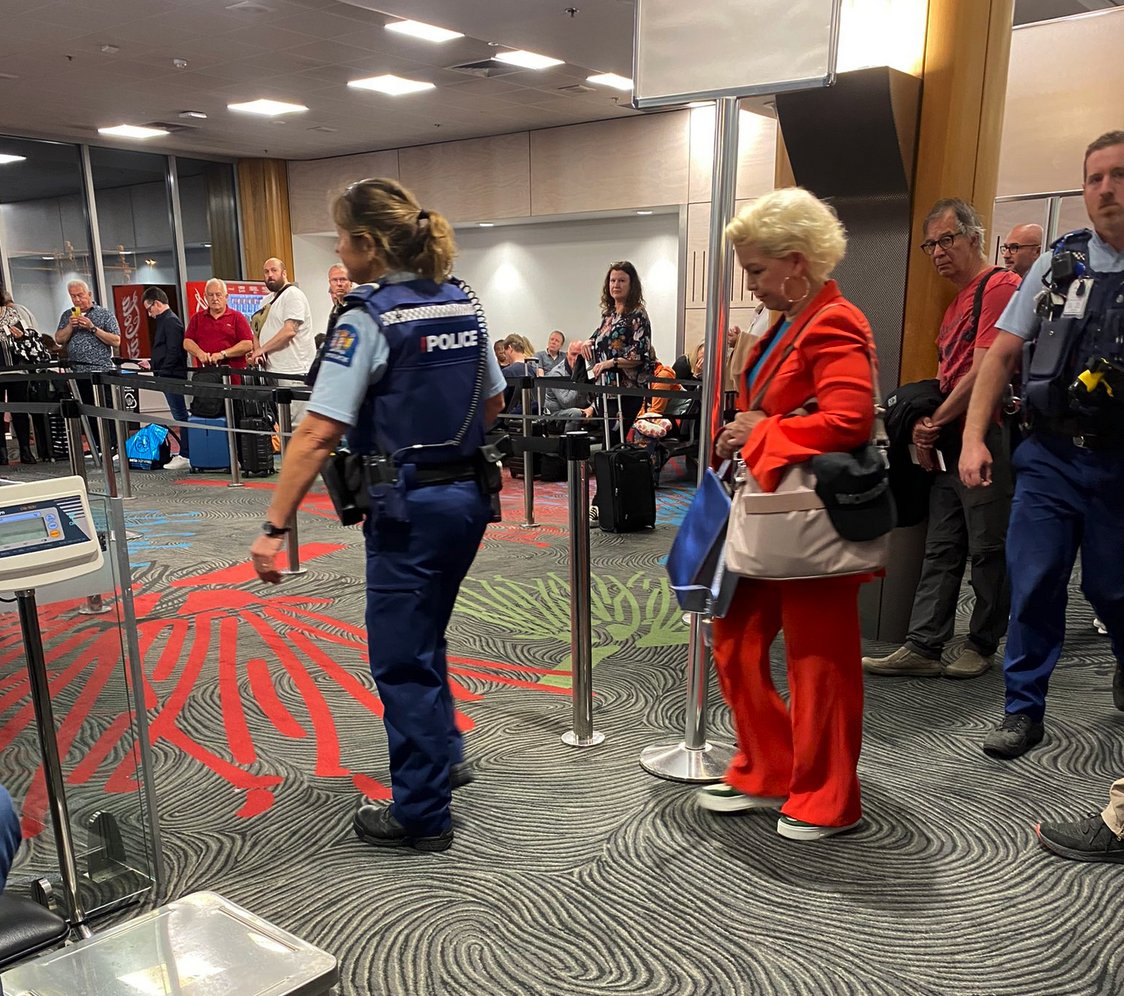 me2intheuk's tweet photo. @hatpinwoman Can anyone post a picture like this of a single TQ++++++
person, needing a police escort to walk safely through an airport, ANYWHERE in the world?
#ShameOnNewZealand 
#LetWomenSpeakAuckland https://t.co/8L1ESG9qYG