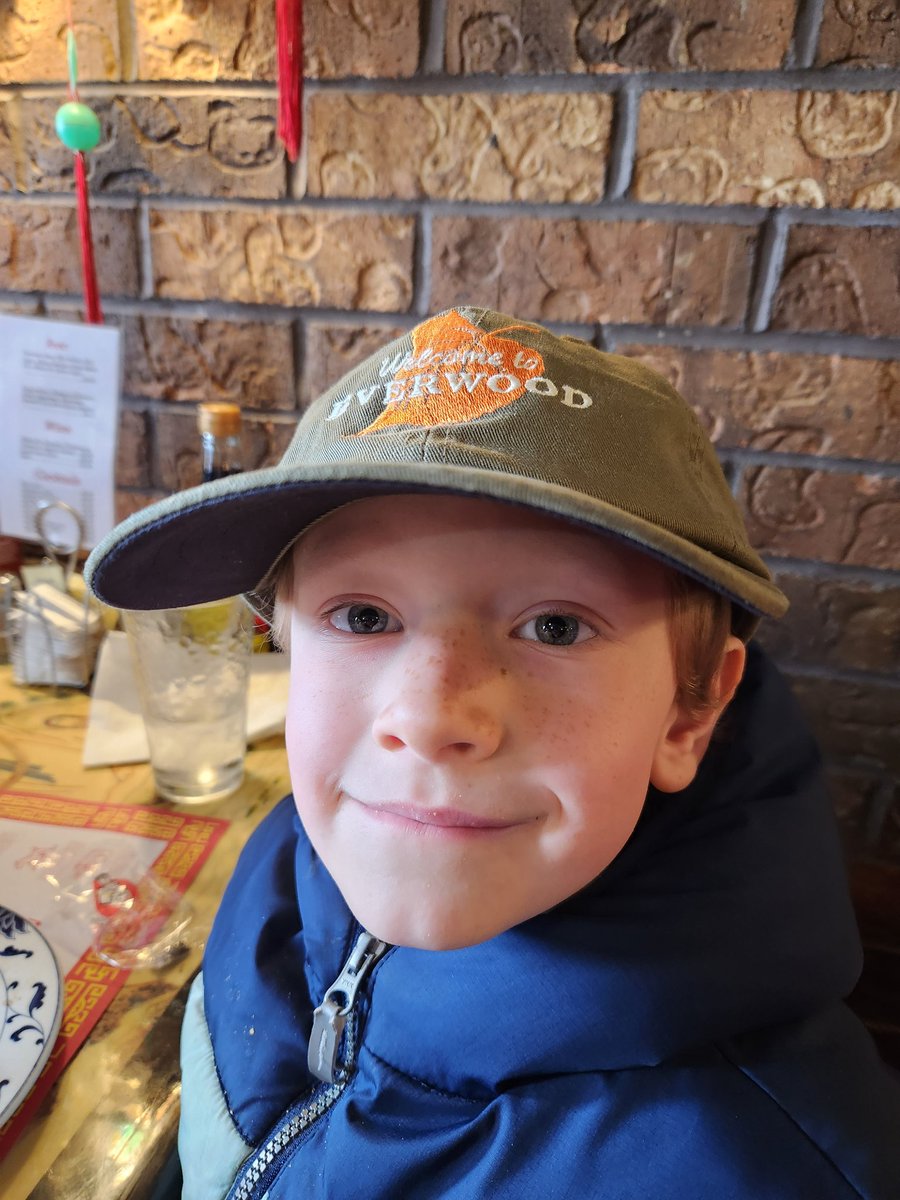 DecentDadReggie's tweet photo. Grayson found an old hat from my tv sales days and won't stop wearing it - "Welcome to Everwood". Maybe he'll be the next  "Bright"/@prattprattpratt https://t.co/2Rf0B696Cx