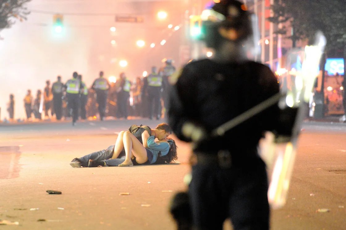 captainmarchand's tweet image. the fact that this picture is from a riot that occurred because of a vancouver canucks vs boston bruins game and not like a political conflict is so funny to me