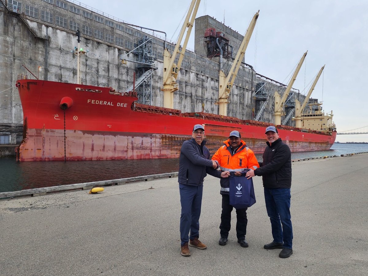 PortofJohnstown's tweet photo. Welcome to the Federal Dee, first “Saltie” of the 2023 shipping season here to load out corn. Welcoming Captain Kuruvilla Phillips are Port GM Robert Dalley and Mayor Tory Deschamp. @fednavlimited #fednav #FederalDee https://t.co/qtzBEKEpCa