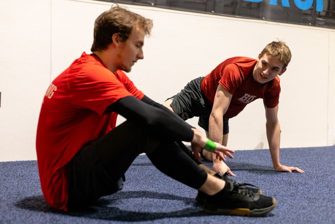 Lane and Quinn Hutson stretching pregame.