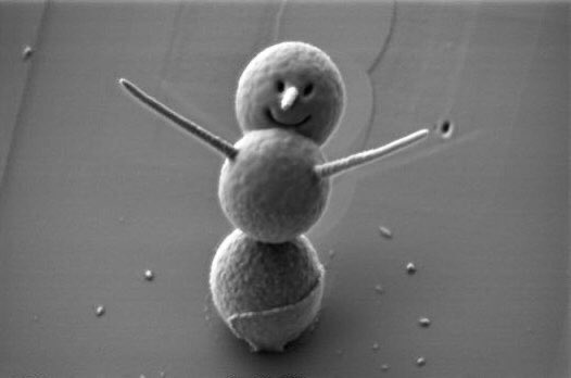microscopicture's tweet photo. the world’s smallest snowman is less than 3 microns tall and was built from silica spheres. the eyes and mouth were cut with a focused ion beam and the arms and nose were sculpted with platinum. magnification 25,000x https://t.co/cXie77t5dA