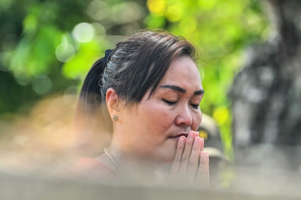 Indonesian ethnic Chinese people gather for prays at a cemetery as they visit deceased family members during the Cheng Beng or Qingming Festival, also known as Tomb-Sweeping Day, at a Chinese cemetery in Japakeh on the outskirts of Banda Aceh on March 26, 2023.