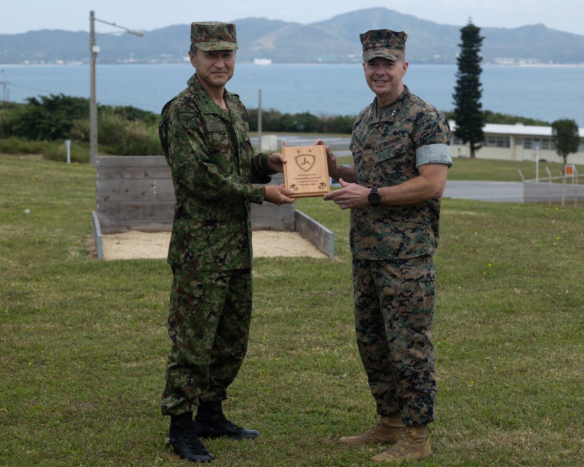 Japan Ground Self-Defense Force Maj. Gen. Kazutomo Idogawa, commanding general of 15th Brigade, JGSDF (left), meets with U.S. Marine Corps Maj. Gen. Jay Bargeron, commanding general of 3d Marine Division (right), on Camp Courtney, Okinawa, Japan.