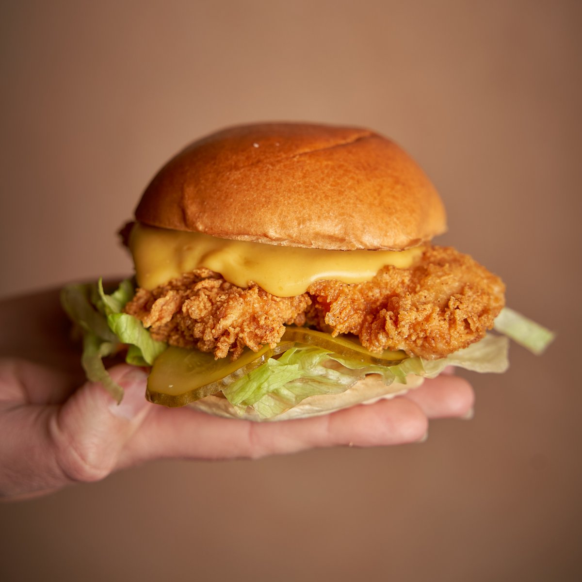 ThunderbirdCKN's tweet photo. All eyes on you MELTDOWN. 👀 A slab of crispy FRIED GOLD with molten miso-jalapeño cheese sauce, lettuce and snappy pickles in a squishy bun. 😋⚡ https://t.co/M72AjIxEDO