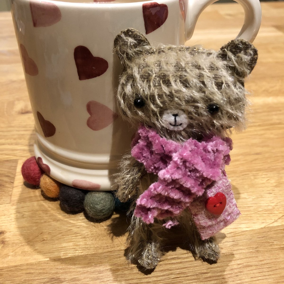 Mondays bear is all set for the cooler weather with her pink hand knitted chenille scarf.
She carrying a cute pink Harris Tweed bag decorated with a red heart button to keep all her essentials in. 
#bears #CollectibleBears #handsewn #unique #bear #mohairbear #collectorsbear