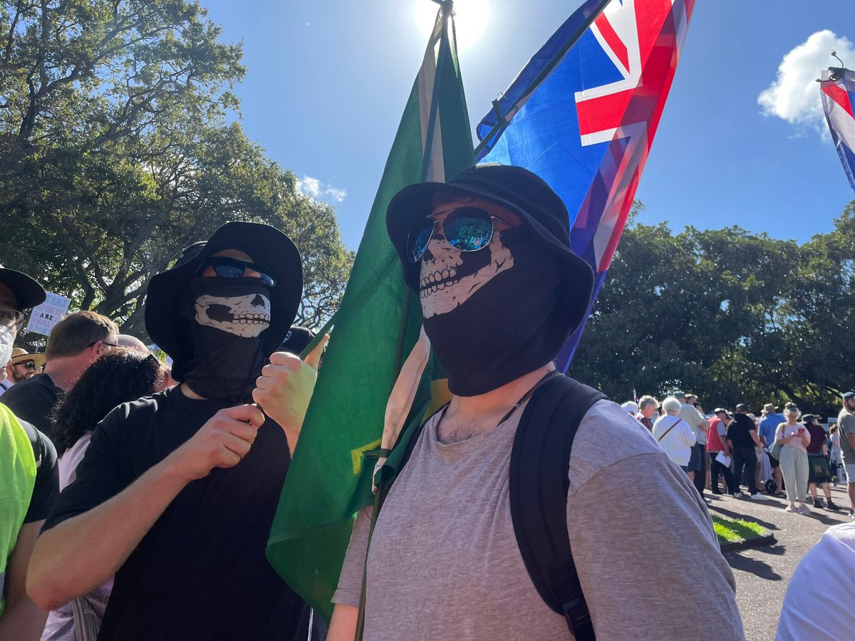 Paparoa3's tweet photo. REVEALED: The Neo-Nazi that held an Irish flag who was part of the Nazi skull mask contingent at Saturday's event in Tāmaki Makaurau by  British far-right transphobe is Christchurch traditionalist Catholic Neo-Nazi Sam Brittenden. https://t.co/SksE2wWejO