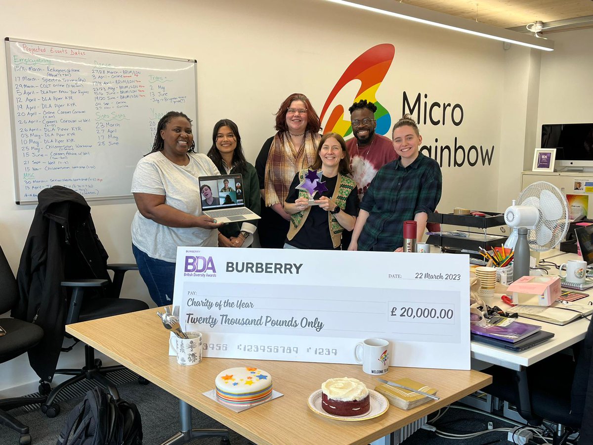 MicroRainbow's tweet photo. We took our @BritDiversity #CharityOfTheYear award into the office for a group pic with the team! (plus some cake to celebrate 🧁) https://t.co/5RDNzm6Rc4