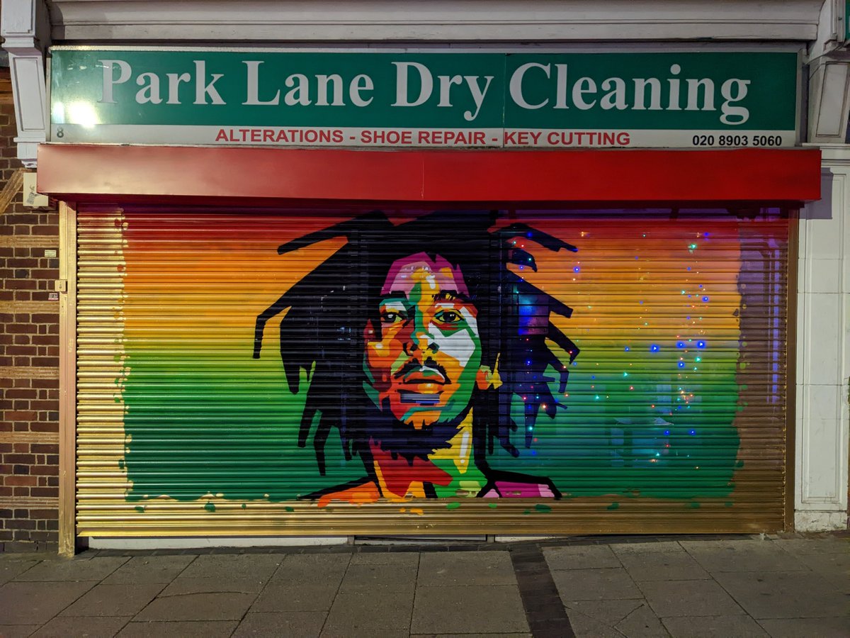 The shutter is being removed from this shop because the mechanism is broken. Is there anyone who would be interested in it as art or who can recommend a place to hang it? It was painted as part of our Wembley art trail. #streetart #shutterart