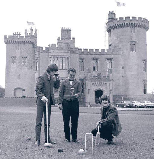 During a much needed stay at Dromoland Castle in Ireland, John Lennon and George Harrison are served drinks whilst indulging in some croquet.