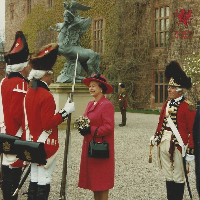 RWFMuseum's tweet photo. Queen Elizabeth inspecting reenactors at the Royal Welch Fusiliers’ Tercentenary Celebration on the 21st April 1989. The reenactors are dressed in replica RWF uniforms from the mid-late 1700s.#wales #visitwales #britisharmy #heritage #soldier #archive #queenelizabeth #reanactors https://t.co/eOXBETsY2J