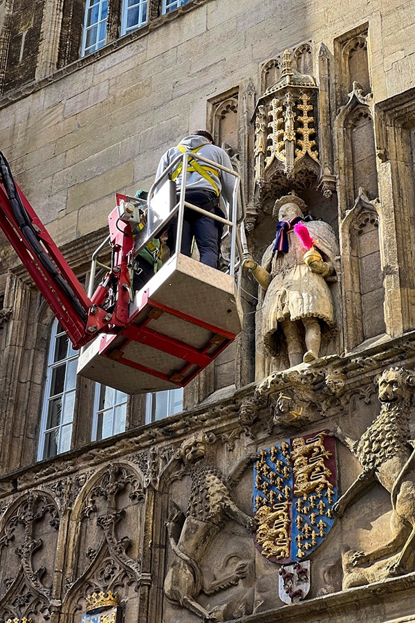 The centuries old rivalry between Trinity College and St John's College was evident today after end-of-term night climbers scaled the main gate of Trinity and placed a pink feather duster under the arm of Henry VIII. A St John's college scarf wrapped around the college founder's