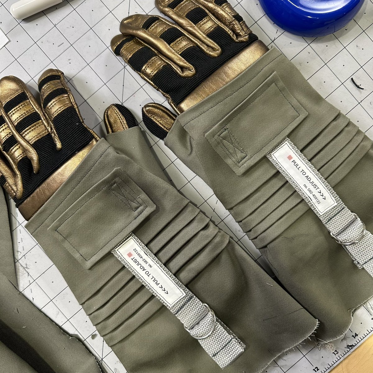 Made gloves for my spacesuit last week:  I sewed overgloves (the green parts) to go on top of purchased leather gloves that I painted bronze. I made the little instructional labels with inkjet-printable fabric. These will be weathered when the rest of the suit is done. Soon!!!