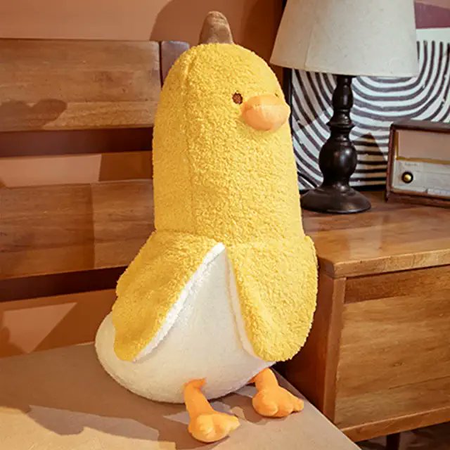 Found whist searching for "duck banana" (long story) on a popular "e-tailer" web site. Stuffed / plushy cute yellow-and-white banana-shaped bird, with legs, eyes and a nose at the top.