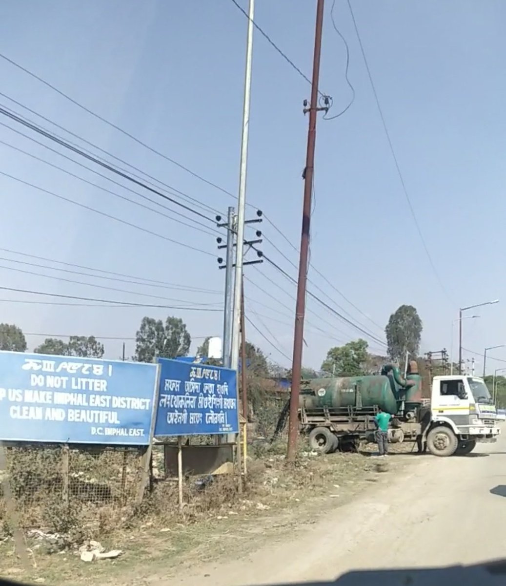 rojitirom's tweet photo. Sometimes,  we don't comprehend things happening around us.  The board says something else and the  Imphal Municipality Garbage truck does something else pouring out the drain beside the road resulting foul smell everywhere.

#ImphalEast #Porompat #GarbageFail #Manipur https://t.co/1pAKgH1xMH