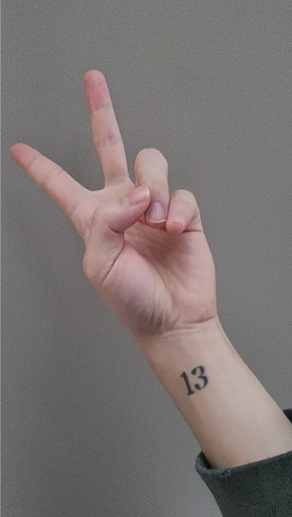 Lucky number 13 tattooed on the wrist