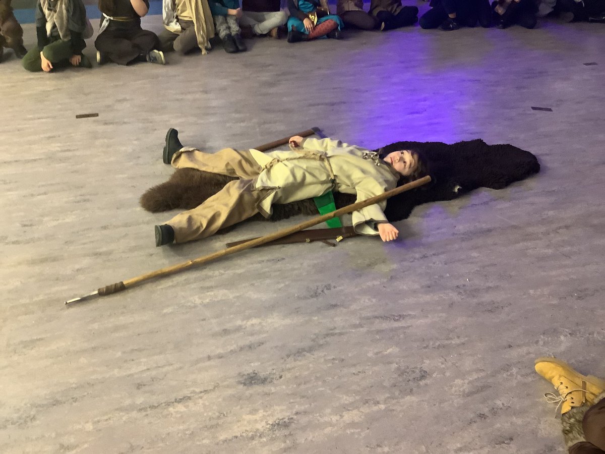 Just burying a dead Viking. Making sure he is being buried with all his expensive possessions. (He’s just acting, he is still alive).