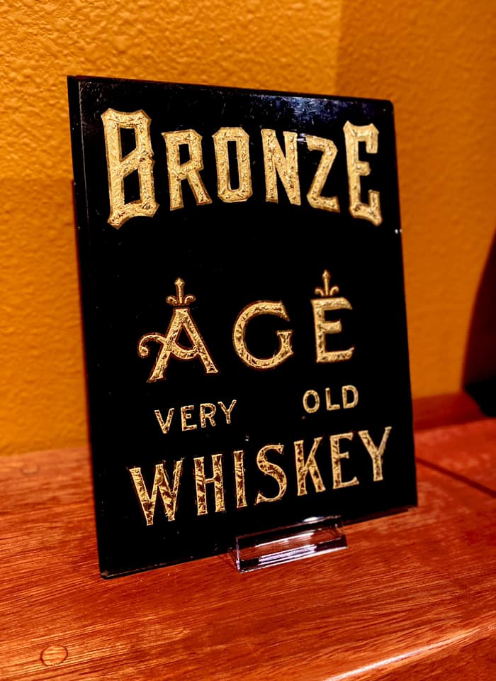 SmallBatchSigns's tweet image. This Reverse-On-Glass (ROG) &apos;Bronze Age&apos; Whiskey sign was missing its gold gilding and in rough shape with severe water staining on the glass surface and superficial scratches, which were buffed out and the sign restored back to its original grandeur.  Here is a Before-and-After.
