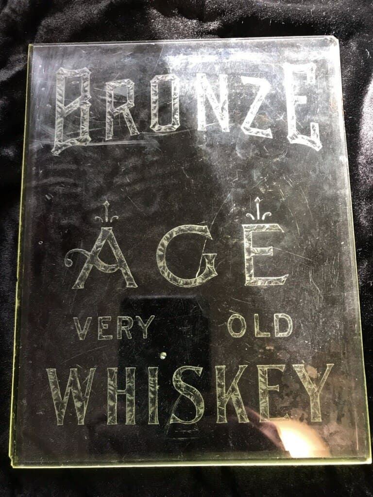 SmallBatchSigns's tweet image. This Reverse-On-Glass (ROG) &apos;Bronze Age&apos; Whiskey sign was missing its gold gilding and in rough shape with severe water staining on the glass surface and superficial scratches, which were buffed out and the sign restored back to its original grandeur.  Here is a Before-and-After.